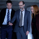 X-Files agents Fox Mulder and Dana Scully stand with Reggie in a large parking garage in "The Lost Art of Forehead Sweat."